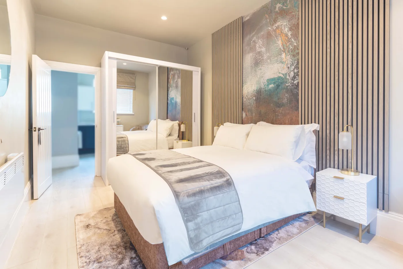 Double bedroom with mirrored wardrobe in a property marketed by Dwelling & Manor